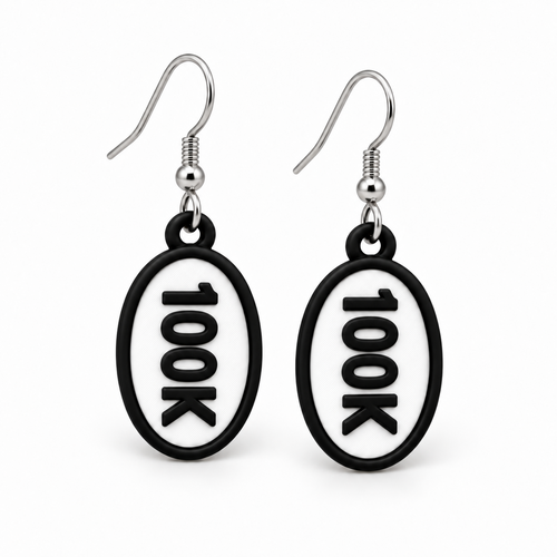 Close-up pair of black-and-white 100K oval distance earrings