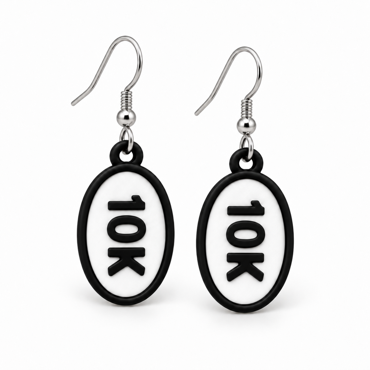 Close-up pair of black-and-white 10K oval distance earrings