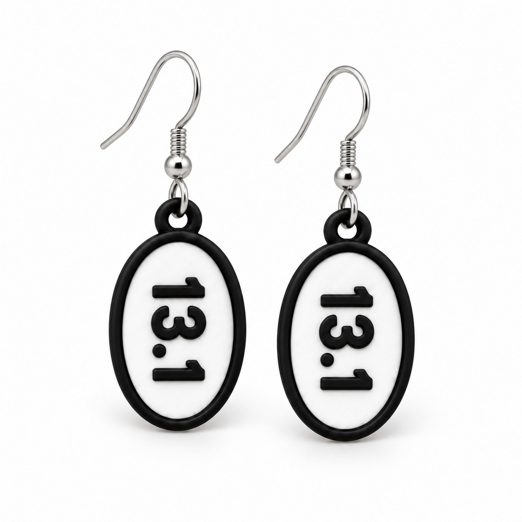 Close-up pair of black-and-white 13.1 oval distance earrings