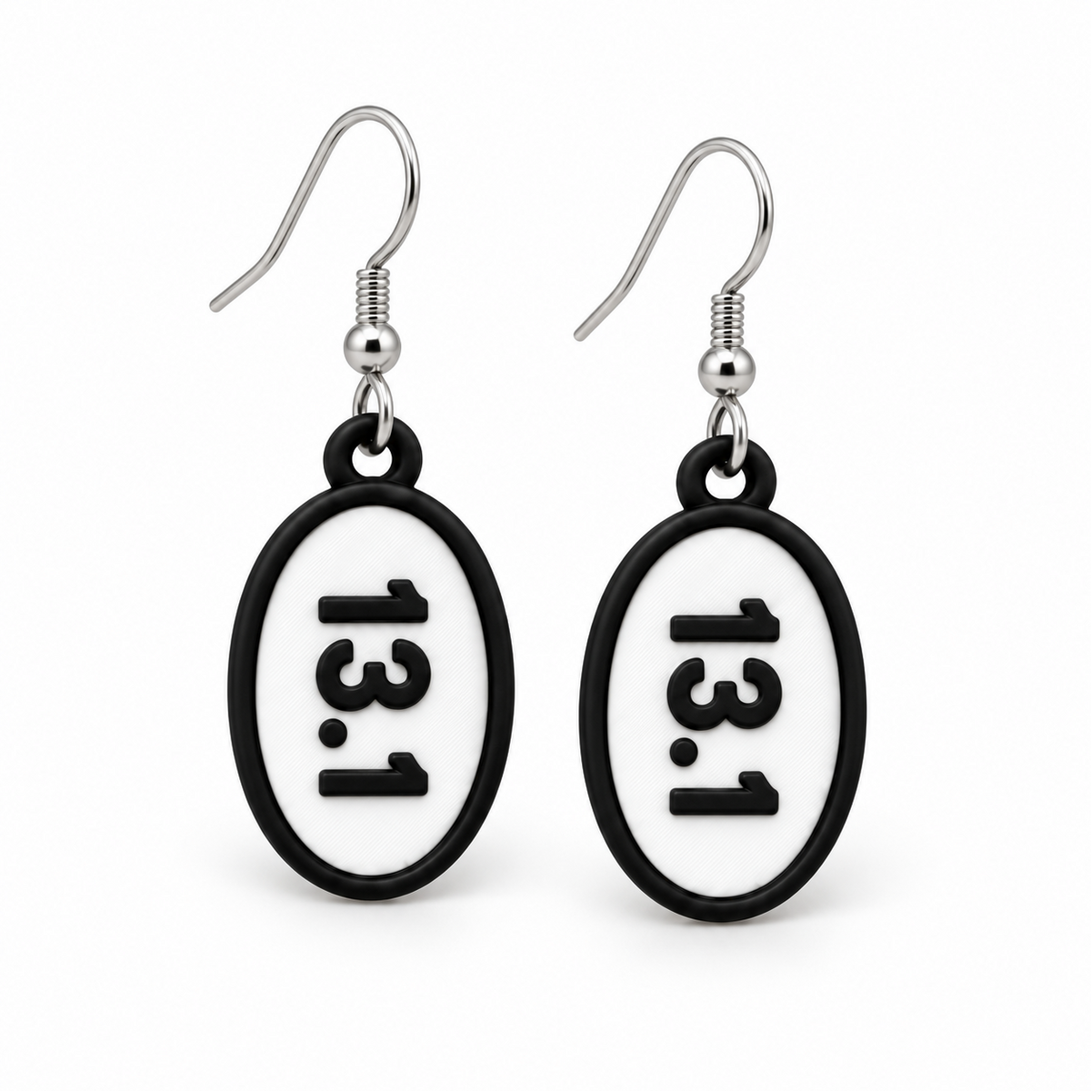 Close-up pair of black-and-white 13.1 oval distance earrings