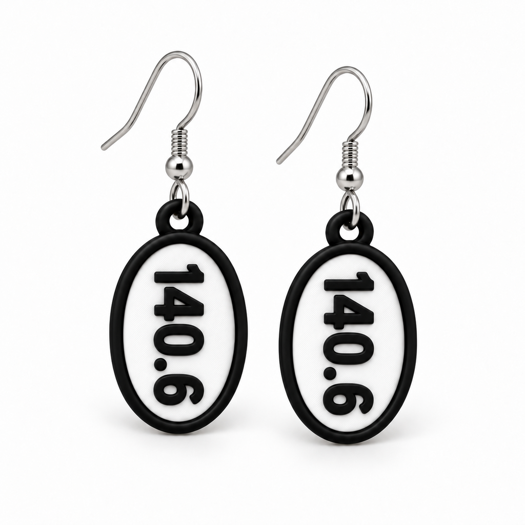 Close-up pair of black-and-white 140.6 oval distance earrings