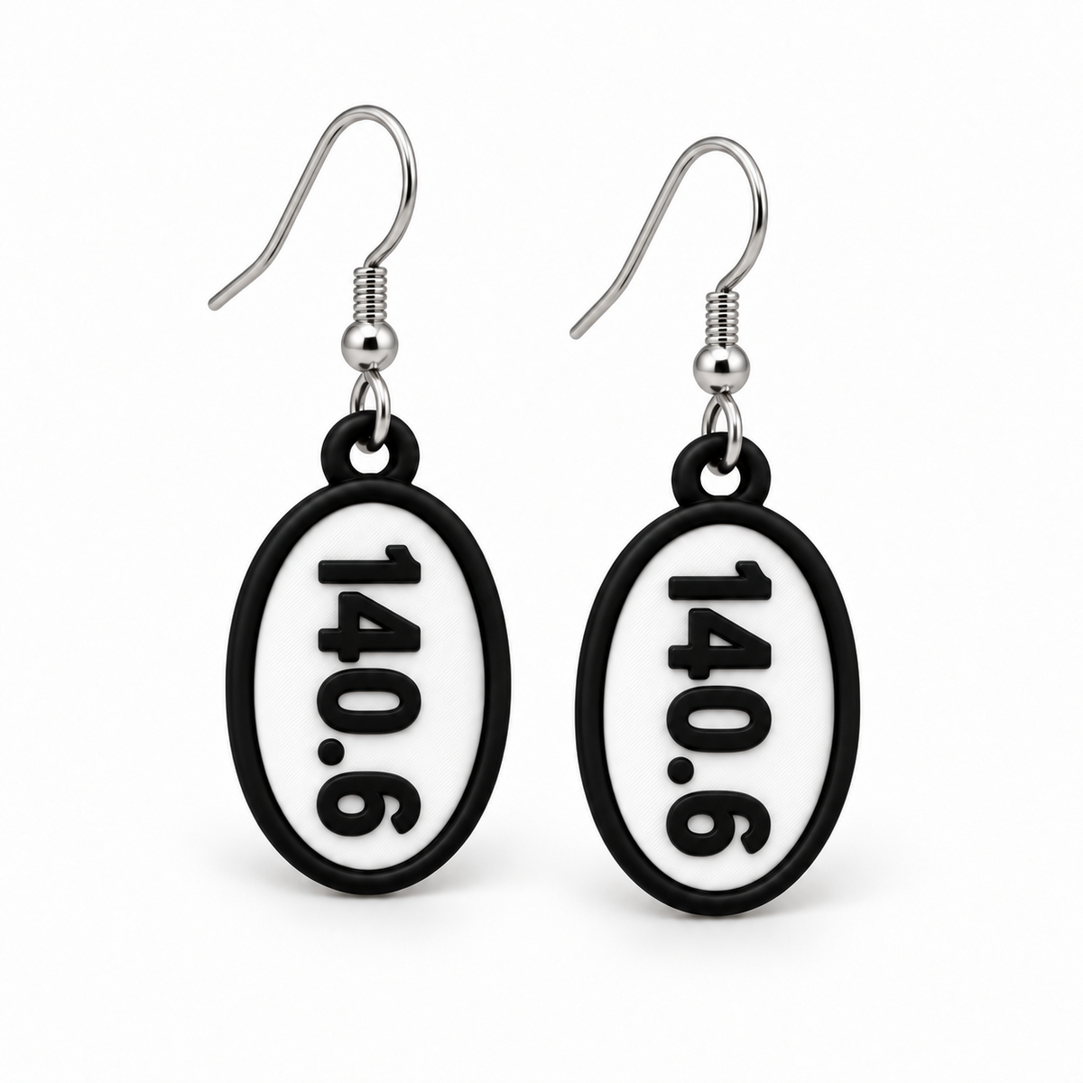 Close-up pair of black-and-white 140.6 oval distance earrings