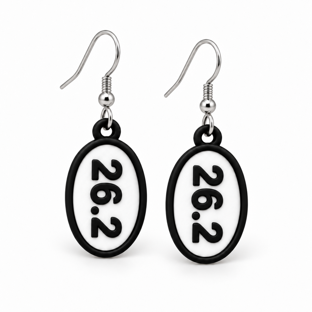 Close-up pair of black-and-white 26.2 oval distance earrings