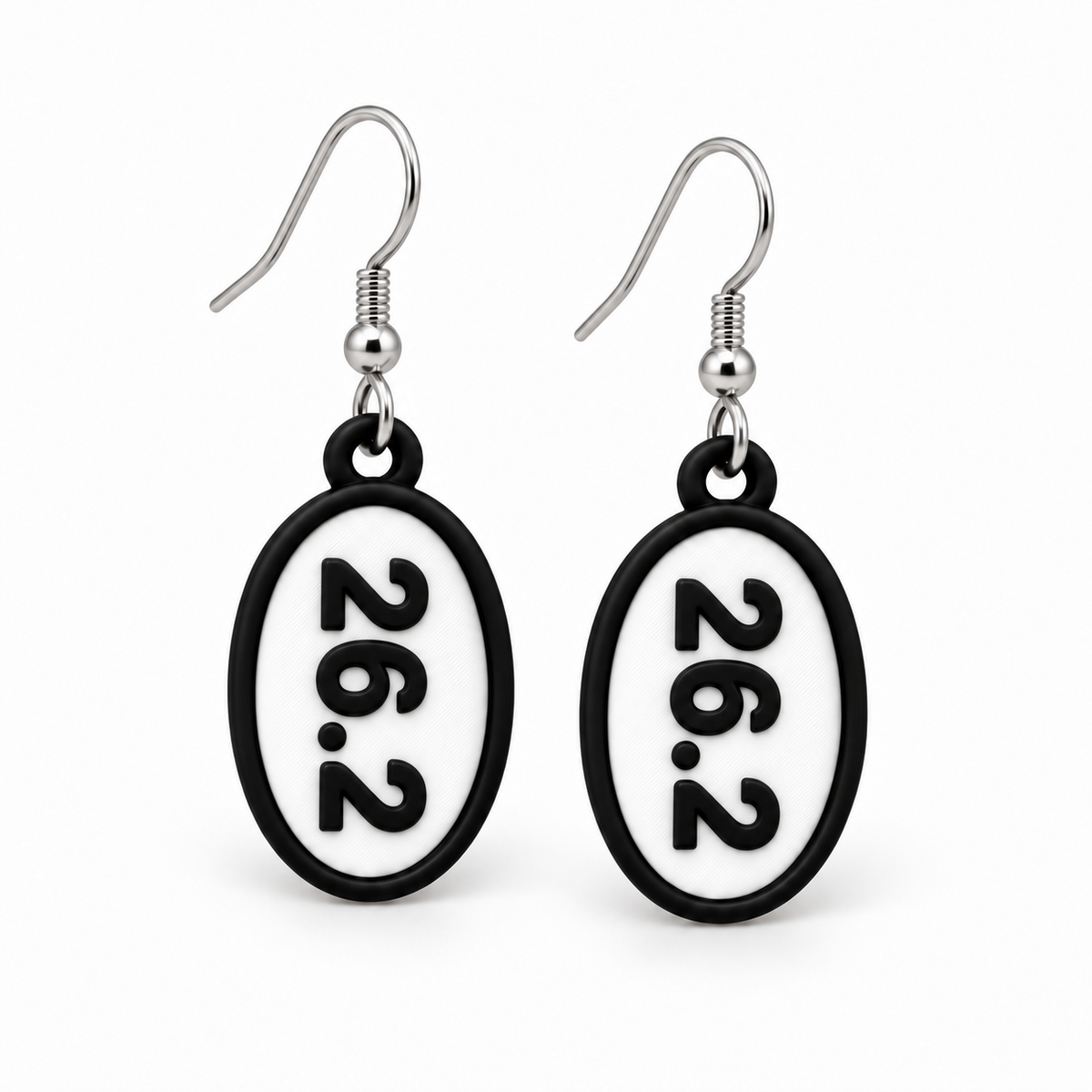 Close-up pair of black-and-white 26.2 oval distance earrings