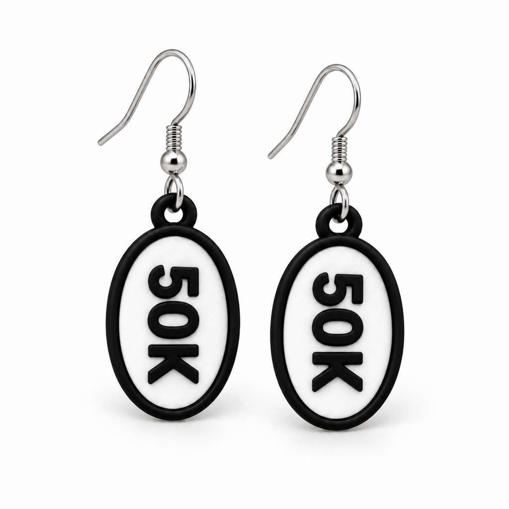 Close-up pair of black-and-white 50K oval distance earrings