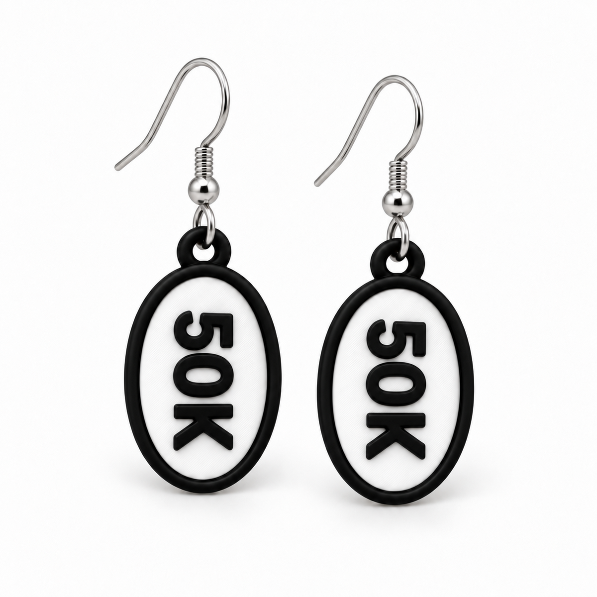 Close-up pair of black-and-white 50K oval distance earrings