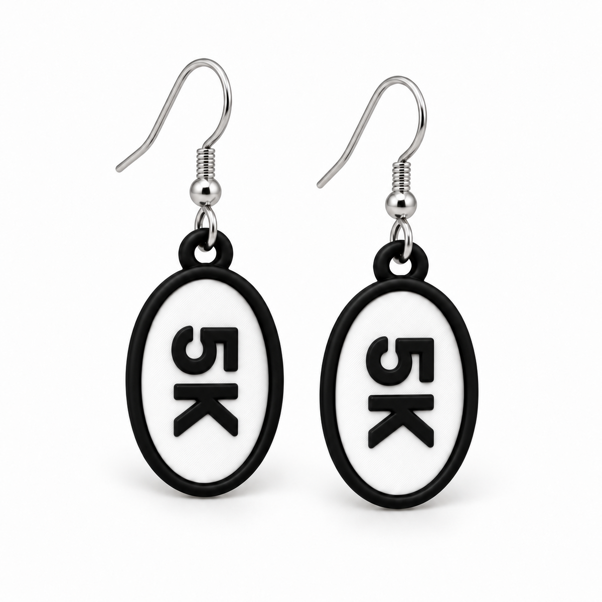 Close-up pair of black-and-white 5K oval distance earrings
