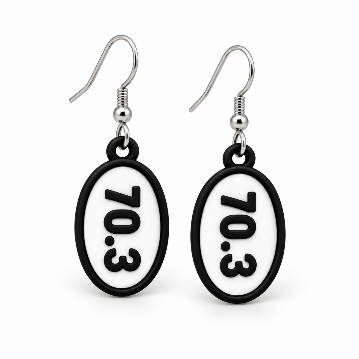 Close-up pair of black-and-white 70.3 oval distance earrings