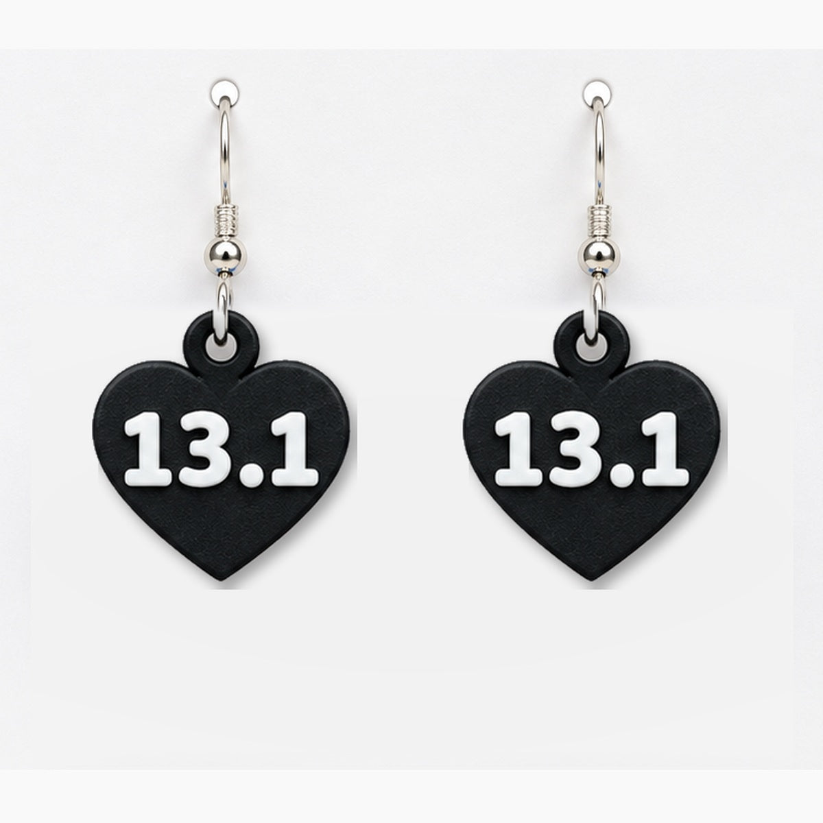 Close-up black 13.1 heart earring pair