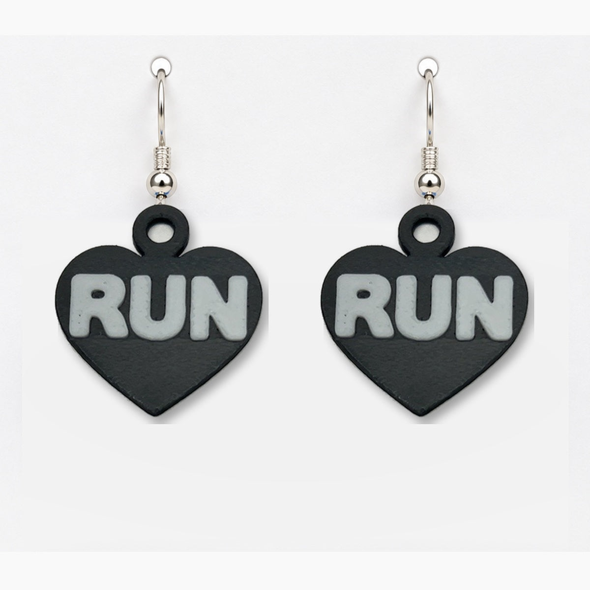 Close-up black RUN heart earring pair