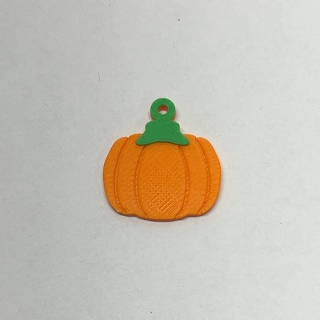 Flat orange pumpkin earring with green stem and printed hanging loop