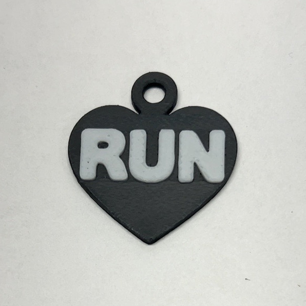 Black heart RUN earring with white lettering