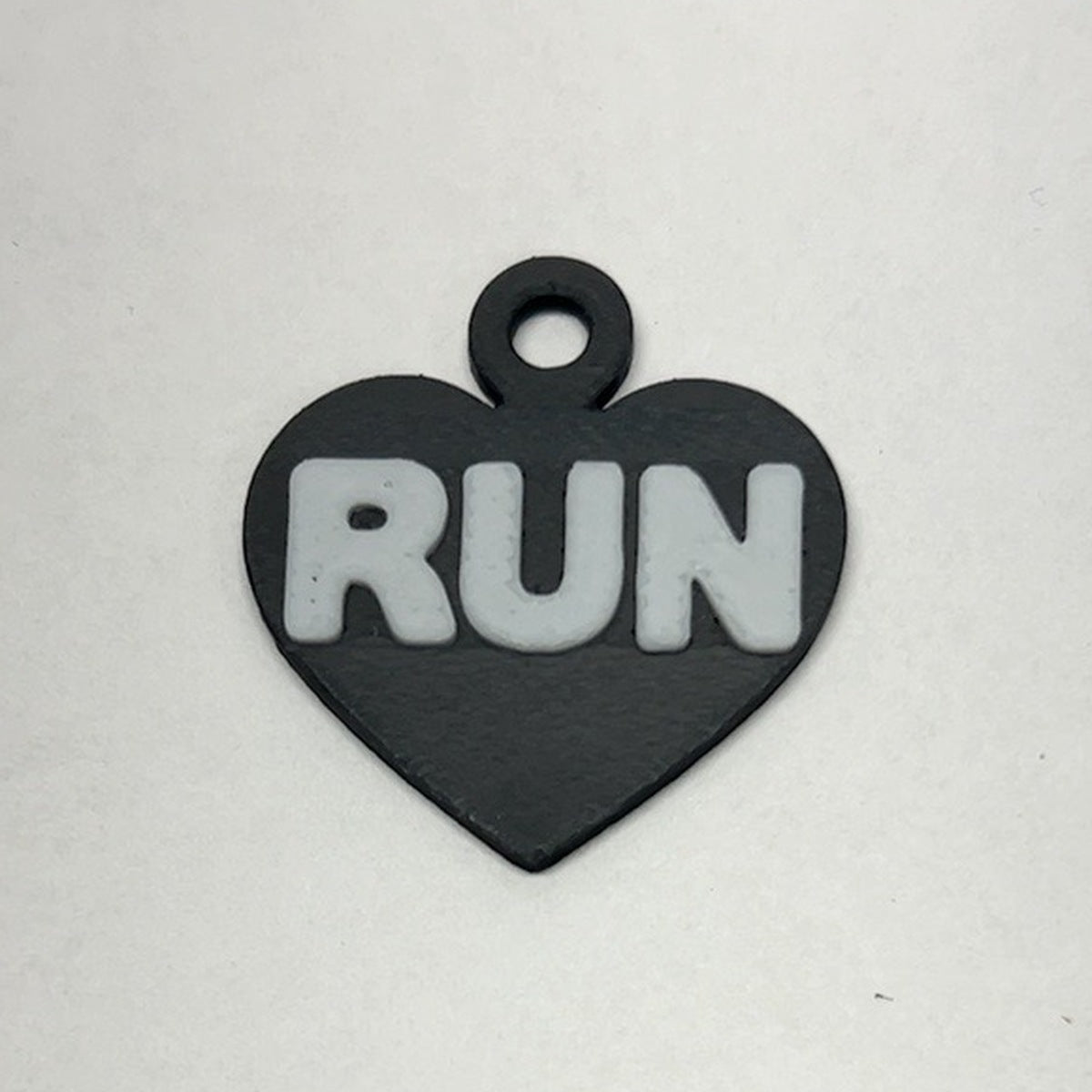 Black heart RUN earring with white lettering