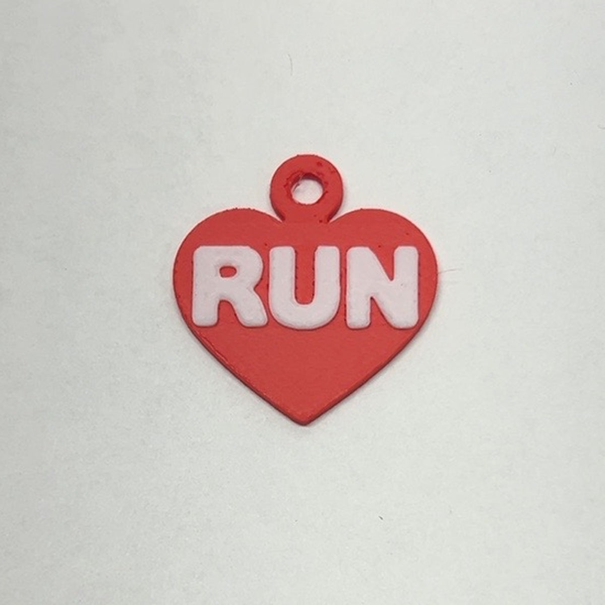 Red heart RUN earring with white lettering